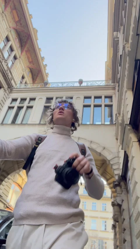 Vertical screen: Urban explorer with camera pauses to admire architectural beaut Stock Footage 305380962
