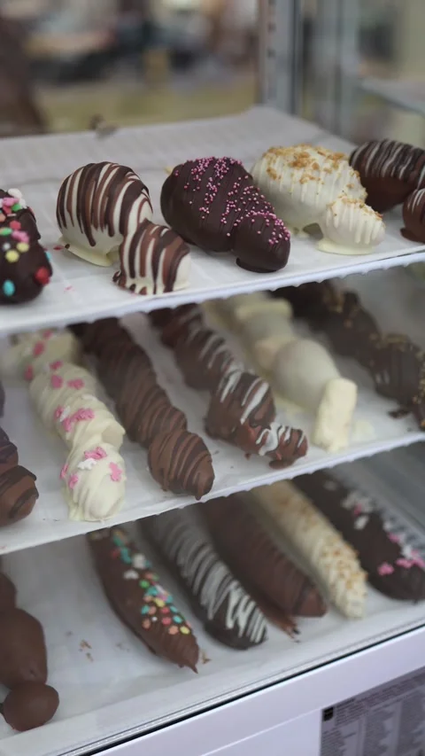 Vertical screen: A variety of chocolate-covered treats in different colors and c Stock Footage 303286009