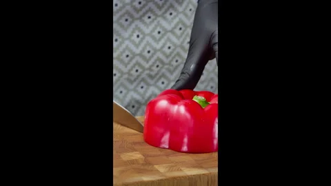 Vertical screen video. Chef using kitchen knife to slice red bell pepper. Stock Footage 302636495
