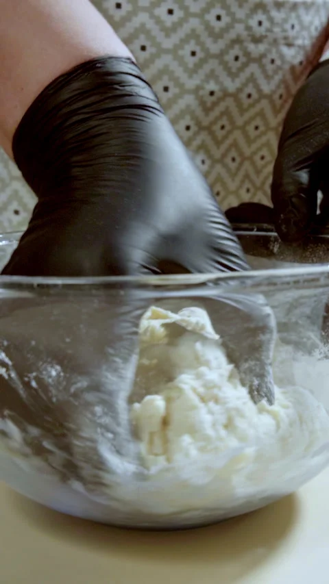 Vertical screen video. Close-up food preparation. Woman hands In knead dough. Stock Footage 301230538