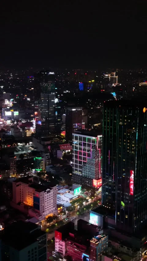 Vertical screen, Vietnam, Ho Chi Minh Aerial Night View Neonlit Skyscrapers Stock Footage 339999530