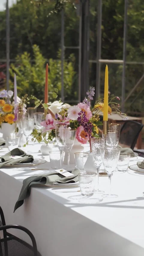 Vertical screen: Wedding decor, glass, flowers, candles. Outdoor Dining Setup Stock Footage 307922184