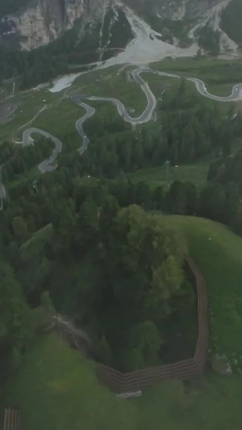 Vertical screen winding road through green mountains, dramatic switchbacks Stock Footage 323890675