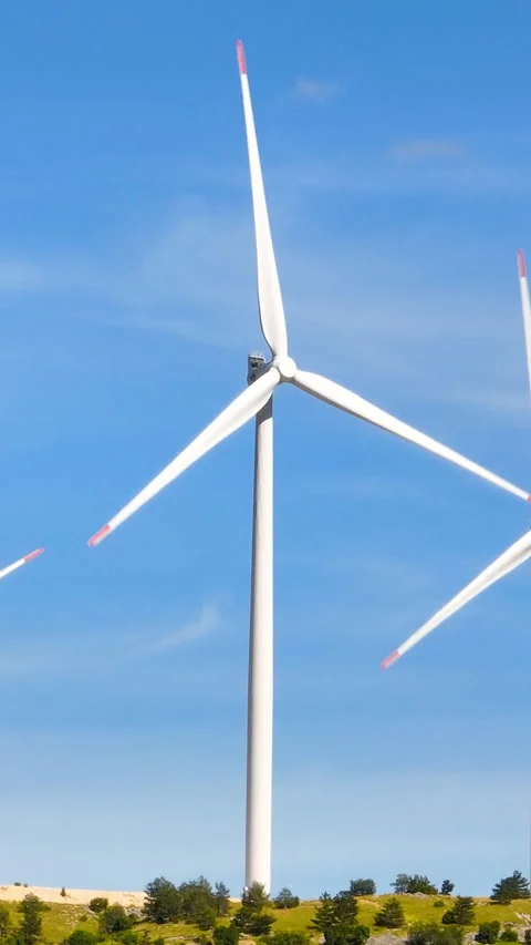 Vertical Screen: Windmills Rotating on a Sunny Day with a Sky Background Stock Footage 281158681