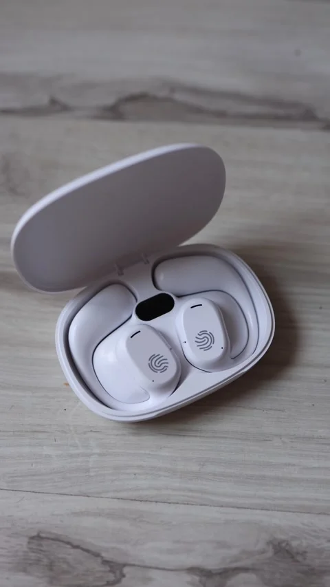 Vertical screen wireless earbuds in charging case sleek white true wireless earp Stock Footage 312175391