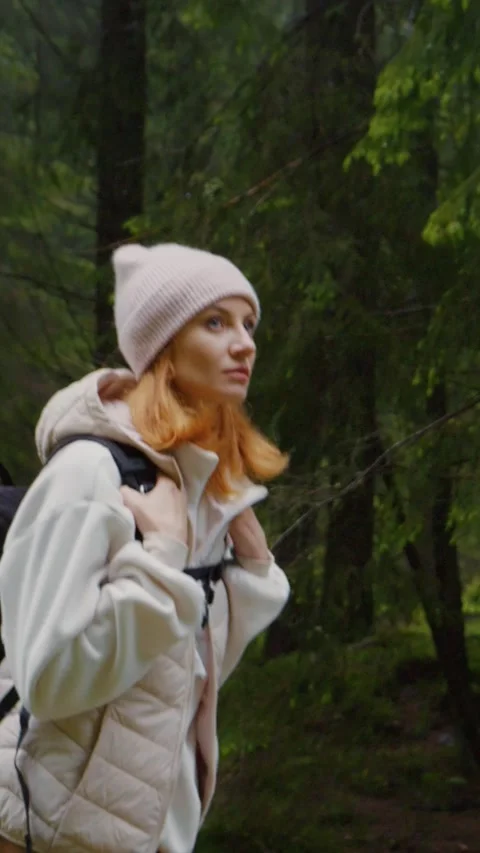 Vertical Screen woman with backpack thoughfully walking in the forest. Stock Footage 299955453