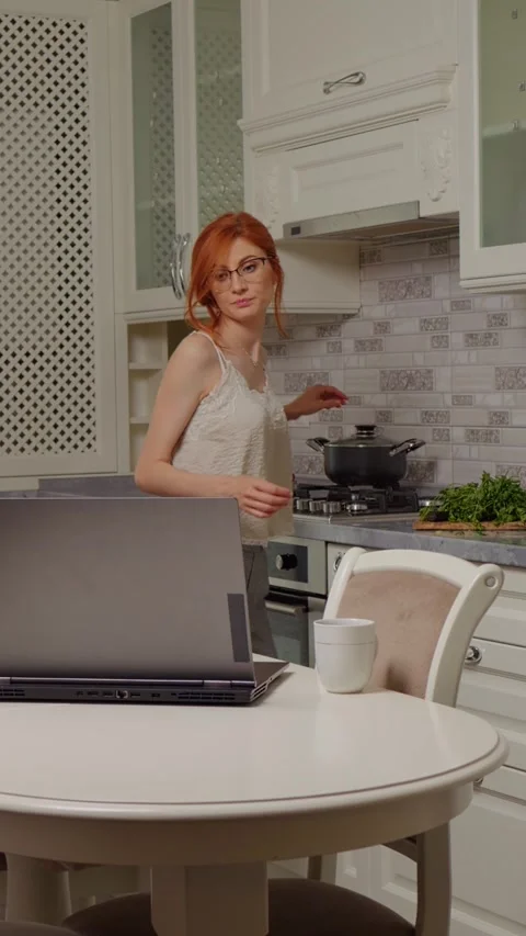 Vertical Screen Woman doing multitasking cooking Video stock 299987375