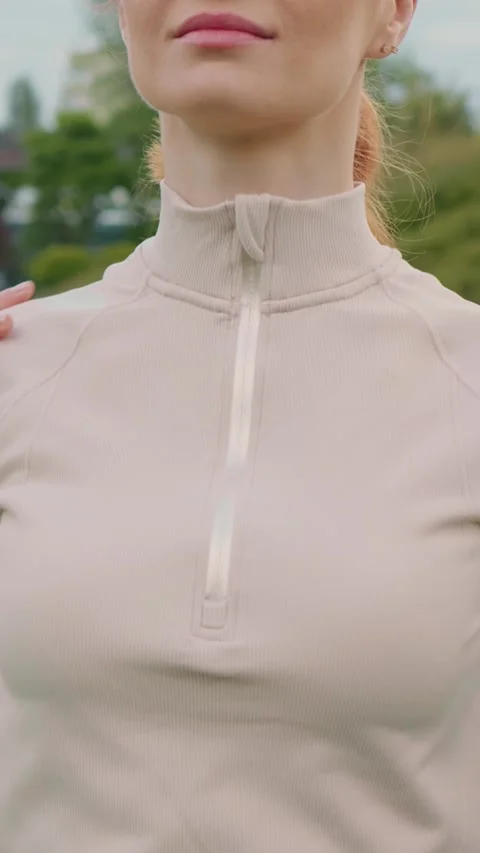 Vertical Screen Woman doing warm up exercise rotating shoulders in the park. Stock Footage 299850048