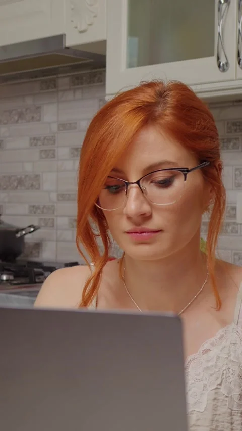 Vertical Screen woman forgets about the boiling pot on the stove. Stock Footage 299987129