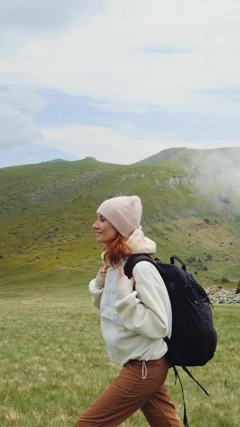 Vertical Screen Woman going down the hill enjoying her freedom in nature. Stock Footage 299955732