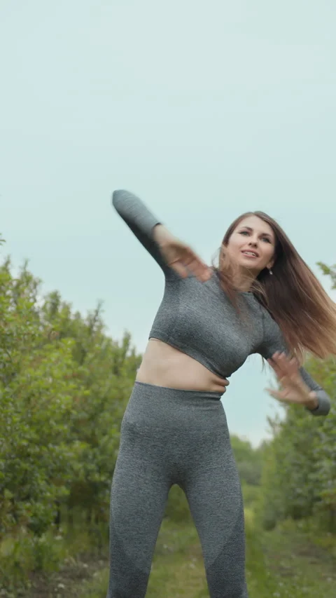 Vertical Screen: Woman runner stretching arms before exercising summer park Stock Footage 274605238
