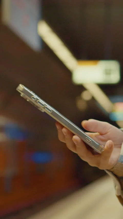 Vertical Screen Woman using phone while waiting for subway Stock Footage 303566437