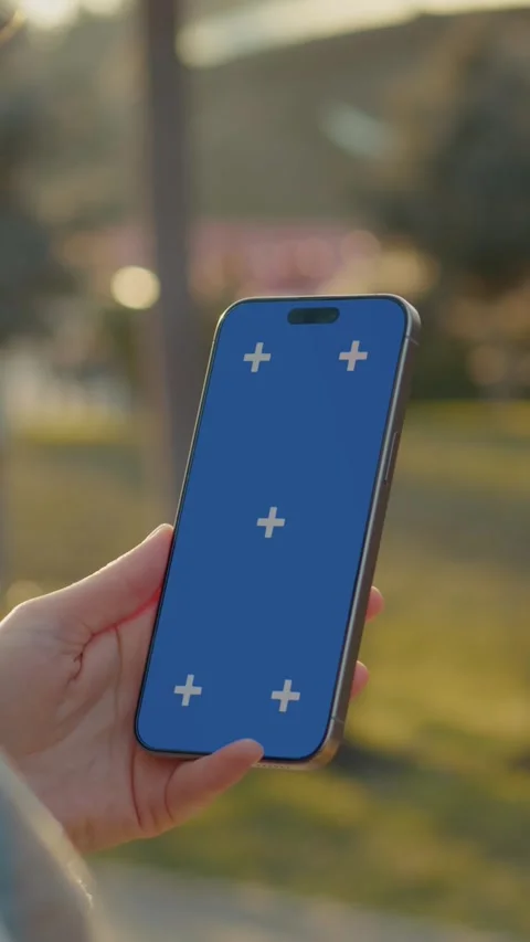 Vertical Screen Woman using smartphone with chroma key screen outdoors Stock Footage 303564231