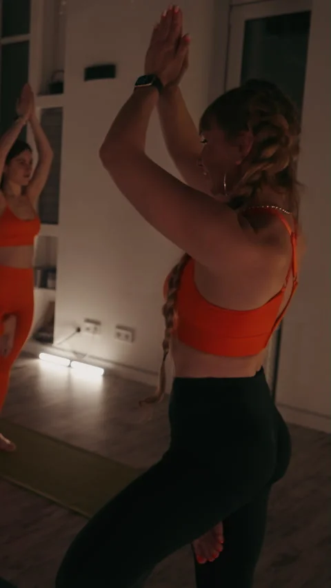 Vertical screen: Women Practicing Tree Pose in Yoga Class Stock Footage 277686545