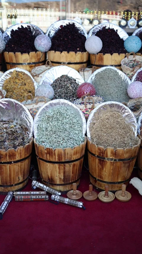 Vertical screen wooden baskets full of herbs dried flowers cinnamon bark and spi Stock Footage 310019211