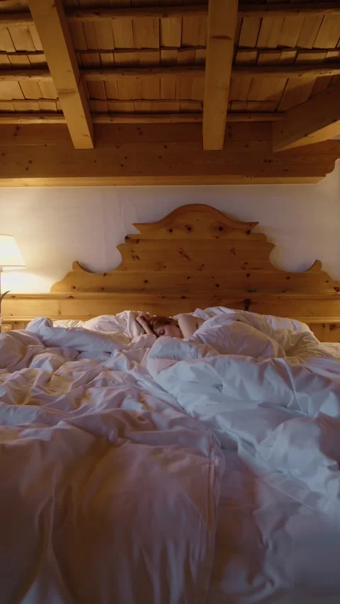 Vertical Screen Wooden bed zoom in and woman sleeping in it while Stock Footage 303441363