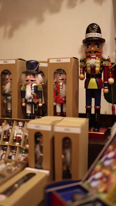 Vertical screen wooden nutcracker figurines in colorful uniforms displayed on ma Video stock 318869293