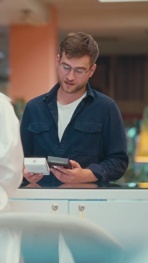 Vertical Screen: Young Caucasian Man Consulting with a Saleswoman Stock Footage 279244835