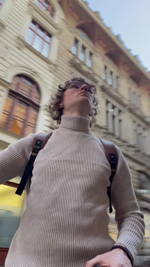 Vertical screen: Young content creator lifts his camera to capture unique angles Stock Footage 305380950