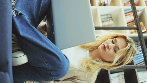 Vertical Screen: Young female freelancer working on laptop Stock Footage 234734795