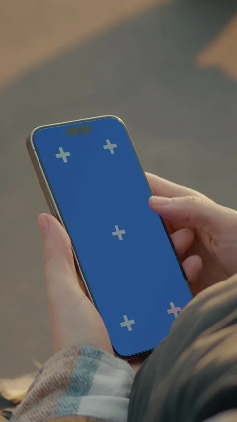 Vertical Screen Young woman using smartphone with blue screen outdoors Stock Footage 303564215