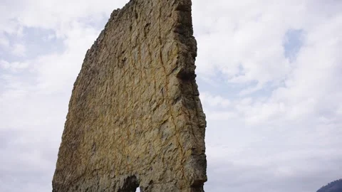 Vertical Sea Cliff Column Dominating The Pebble Beach Landscape Stock Footage 310229133