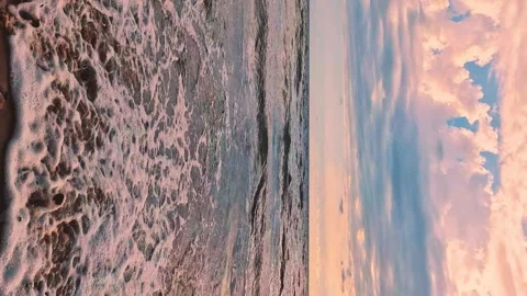 Vertical. Sea Waves Falling Slowly on Sandy Beach at Sunset Peachy Gently Pink O Video stock 297464646