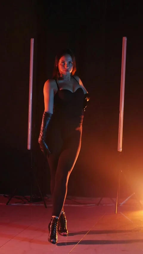 Vertical. Seductive dance performance of sexy woman in black bodysuit Stock Footage 302667313