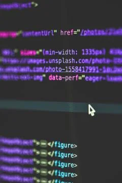 Vertical selective closeup shot of data codes on a computer monitor screen Stock Photos