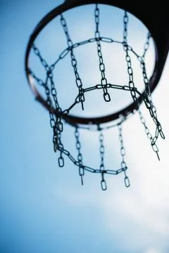 Vertical selective focus low angle shot of a basketball hoop Stock Photos