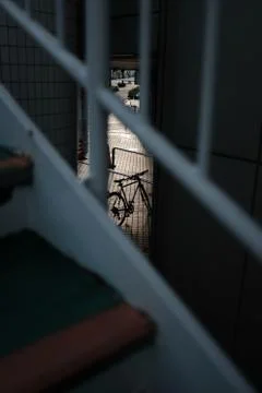 Vertical selective focus shot of a bicycle parked near stairs Stock Photos