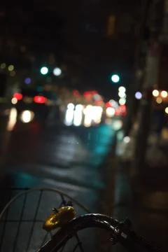 A vertical selective focus shot of a bicycle handle with a golden bell with b Photos