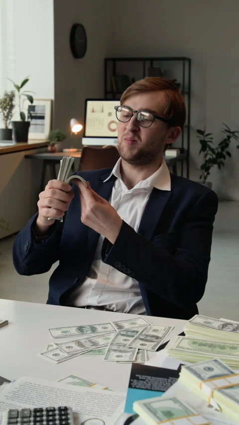 Vertical of Self-Satisfied Young Businessman Enjoying Dollar Bundle Kissing It Stock Footage 331536282