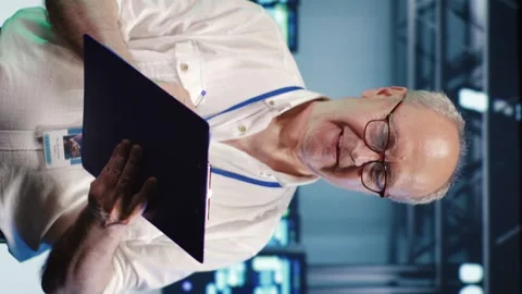 Vertical Serviceman crosschecking server parts Stock Footage 247796350