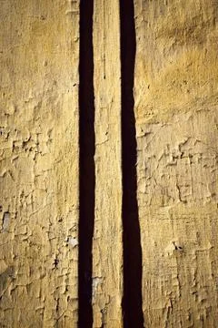 Vertical shadows on the ancient ocher wall Stock Photos