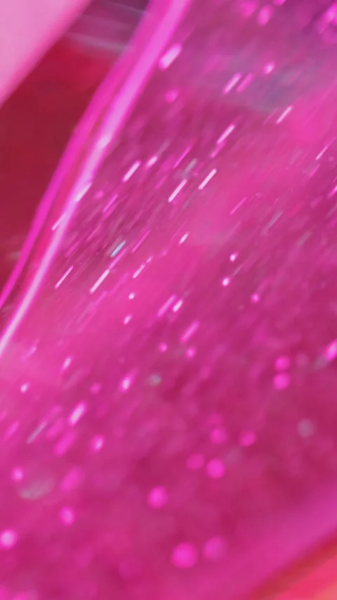 Vertical shimmering fluid background glitter gel pink flow Stock Footage 261422353