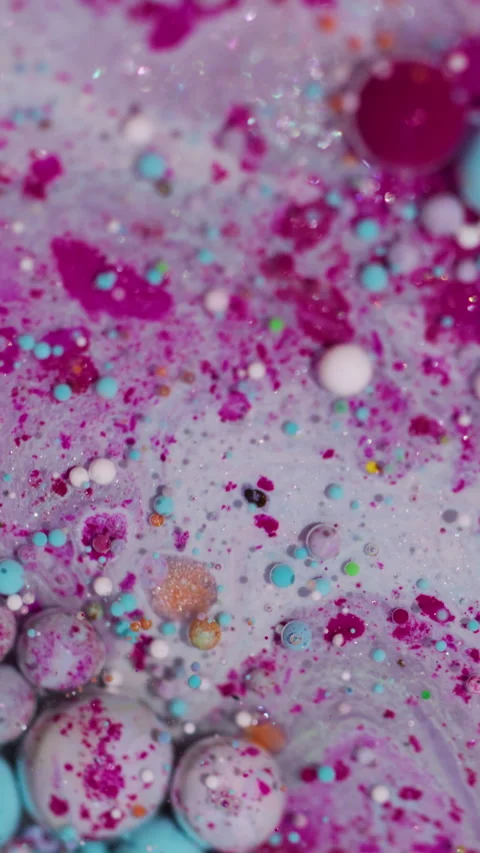Vertical shiny bubble flow ink spill glitter oil Stock Footage 334829135