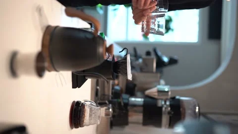 Vertical shoot : barista preparing to brew coffee Video stock 194356703