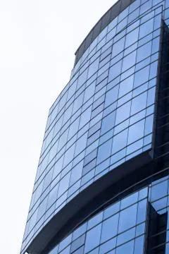 Vertical shoot of blue colored glazing facade mass office building Stock Photos
