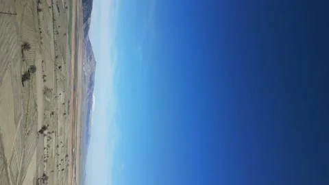 Vertical shoot, the camera from afar flies towards of windmills Stock Footage 233166854