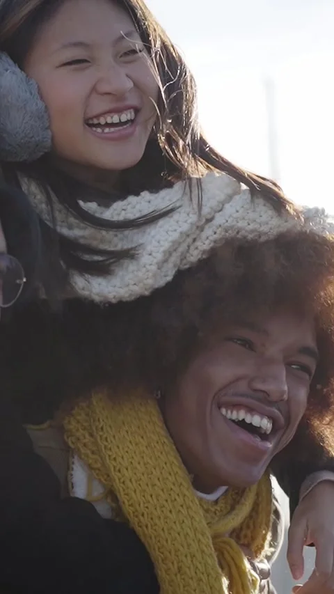 Vertical shoot. Cheerful two couple walking outdoors in a theme park and having Stock Footage 229732460
