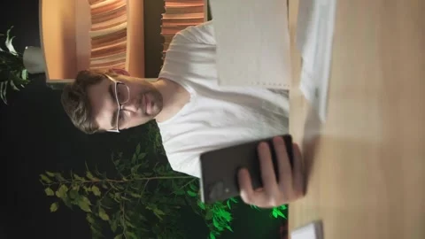 Vertical shooting, a man pays bills through a mobile app Stock Footage 264883515