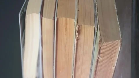 Vertical shooting,A stack of old dusty books falls on the table Stock Footage 264873544