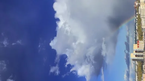 Vertical shooting, timelapse of the city, cloudy sky with a rainbow Stock Footage 262059123