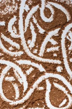 Vertical shot of an abstract pattern of lines drawn on a coffee background Stock Photos
