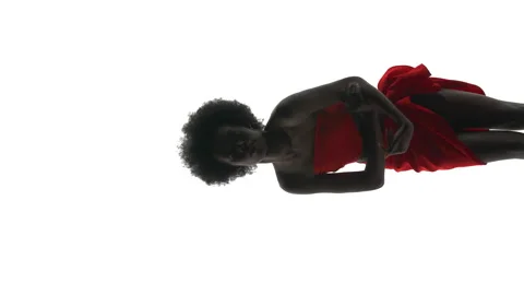 Vertical shot of an African dancer wrapped in red cloth dancing, sensually Video stock 141512276