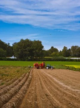 Vertical shot of an agricultural mining machine smoothing the ground. Stock Photos