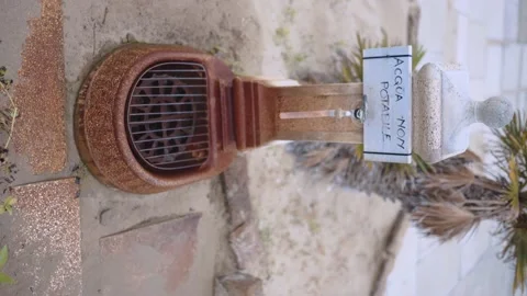 Vertical shot of ancient stone rusty fountain with old ruined bronze faucet Stock Footage 162664862