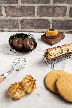 Vertical shot of an array of different gourmet pastries on a kitchen table Fotos de archivo