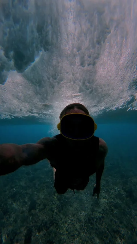Vertical Shot Of Athletic Swimmer Diving Deep Into Blue Ocean Turbulence Foam Stock Footage 330763807